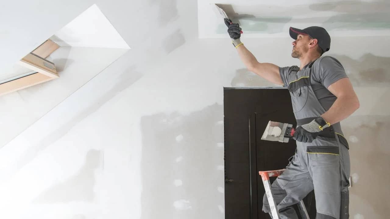 Drywall installer working in a Brindlewood family home